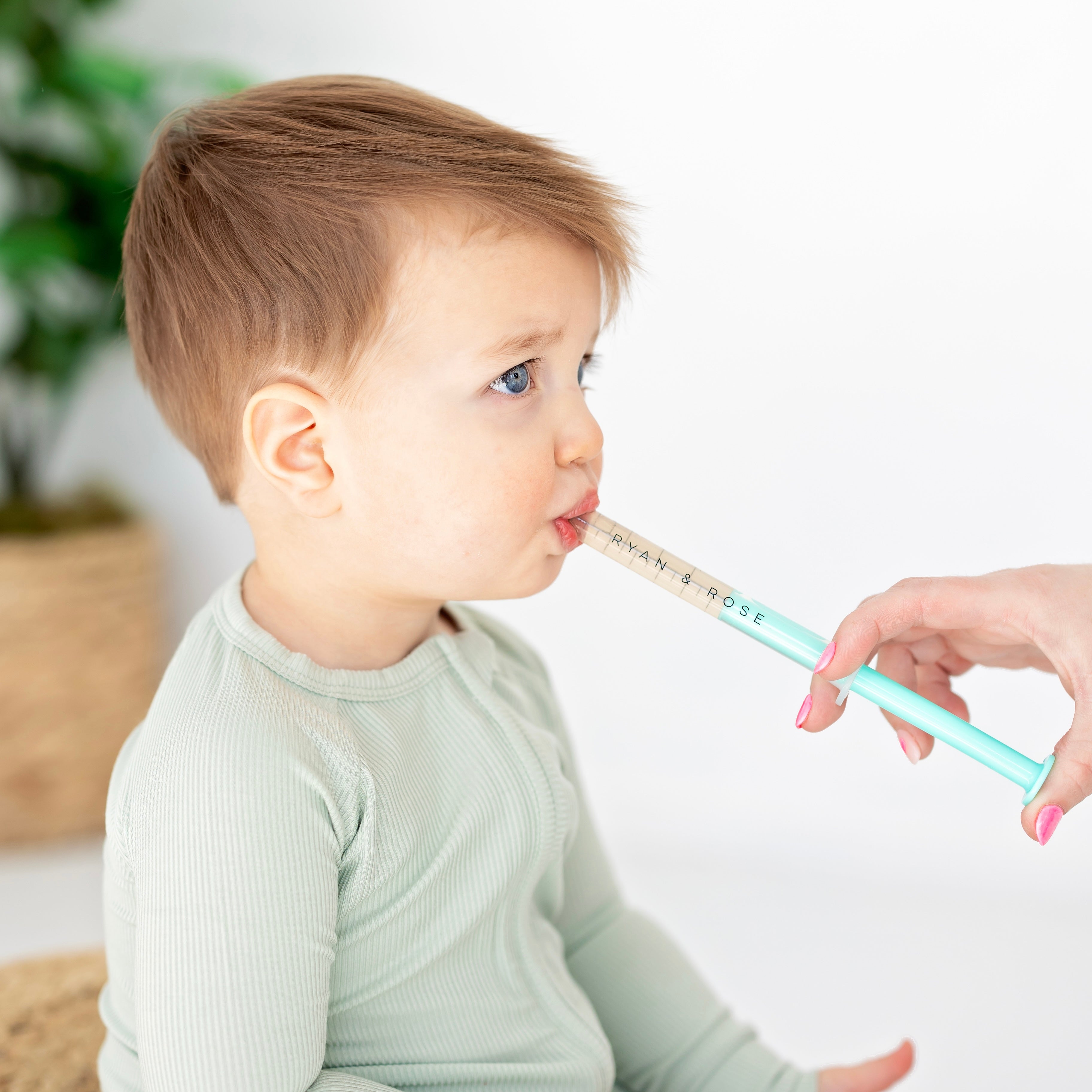 Baby getting medicine with Cutie Dose