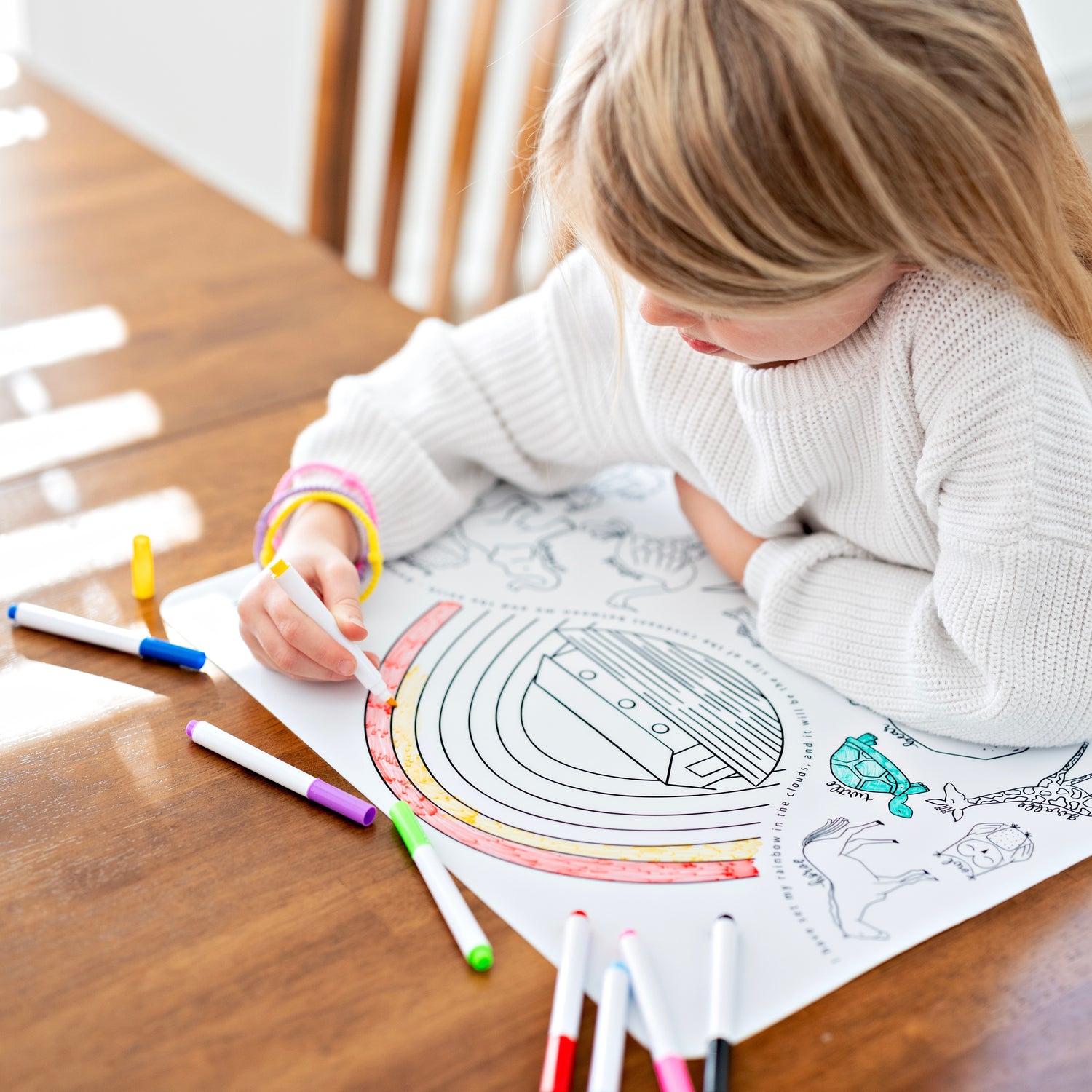 Girl coloring on silicone mat