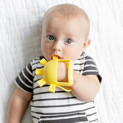 Baby playing with teething mitt