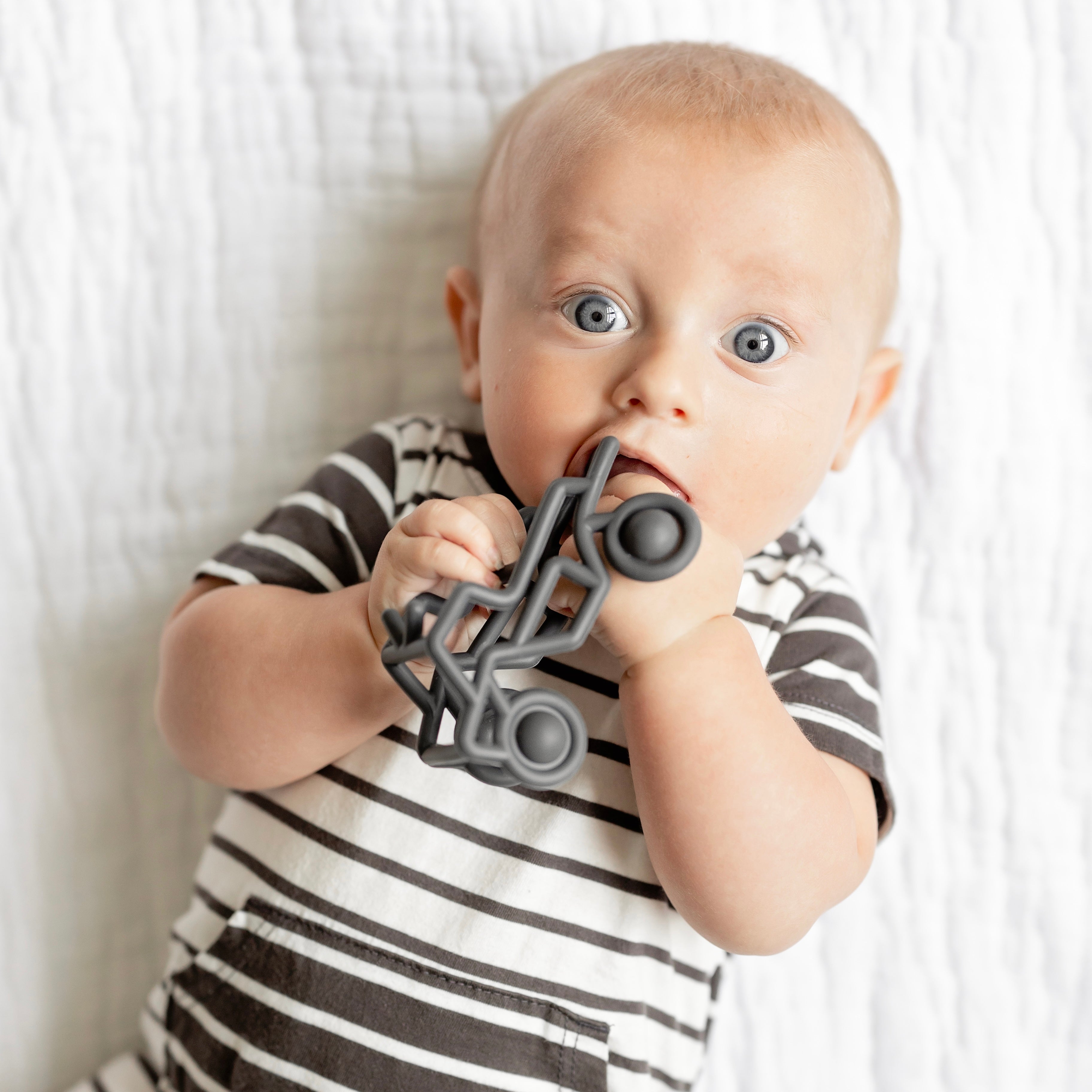 Baby teething on banshee toy