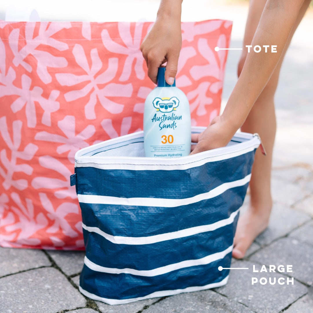 Girl putting sunscreen in a Large Cutie Pouch.