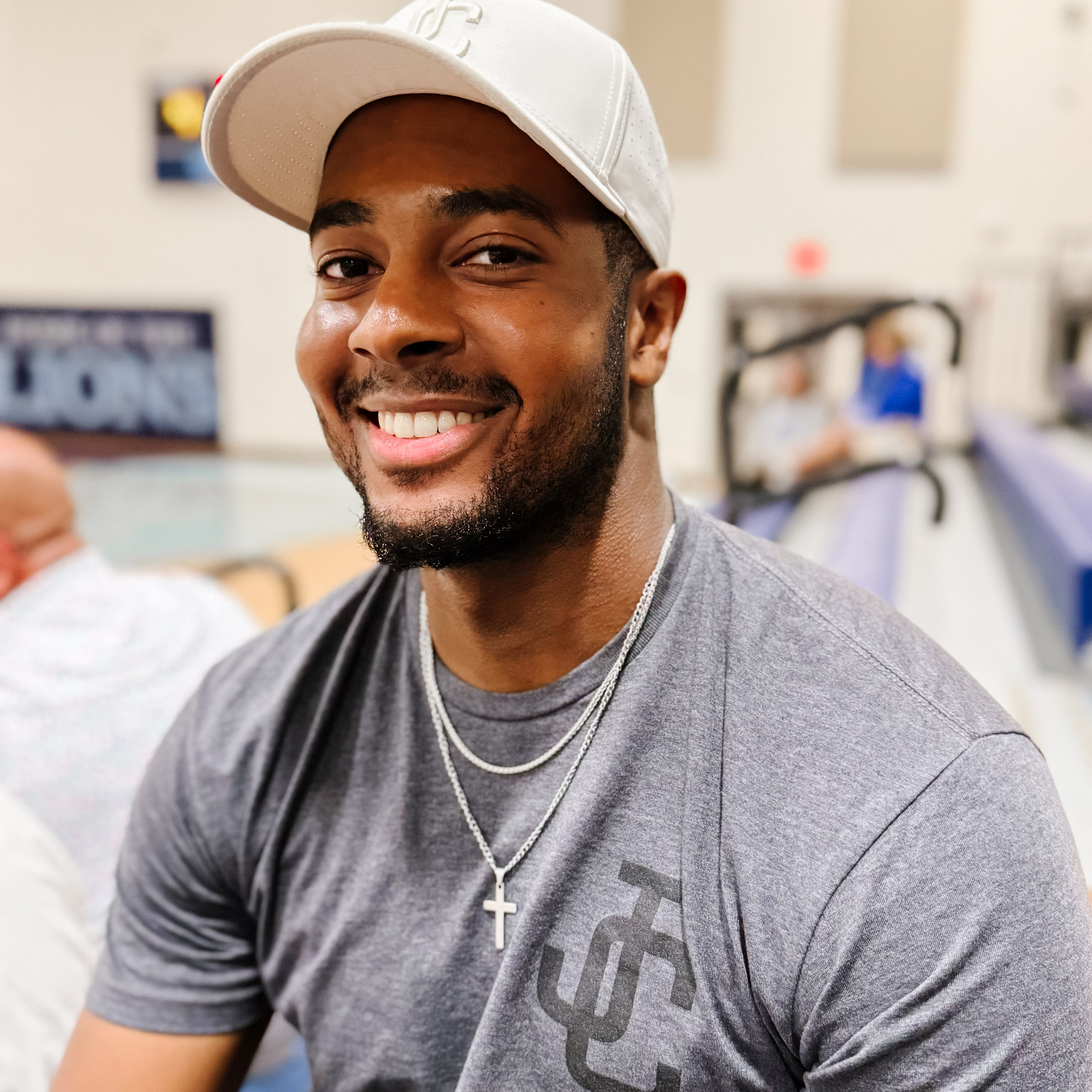 Man wearing JC Hat and Shirt