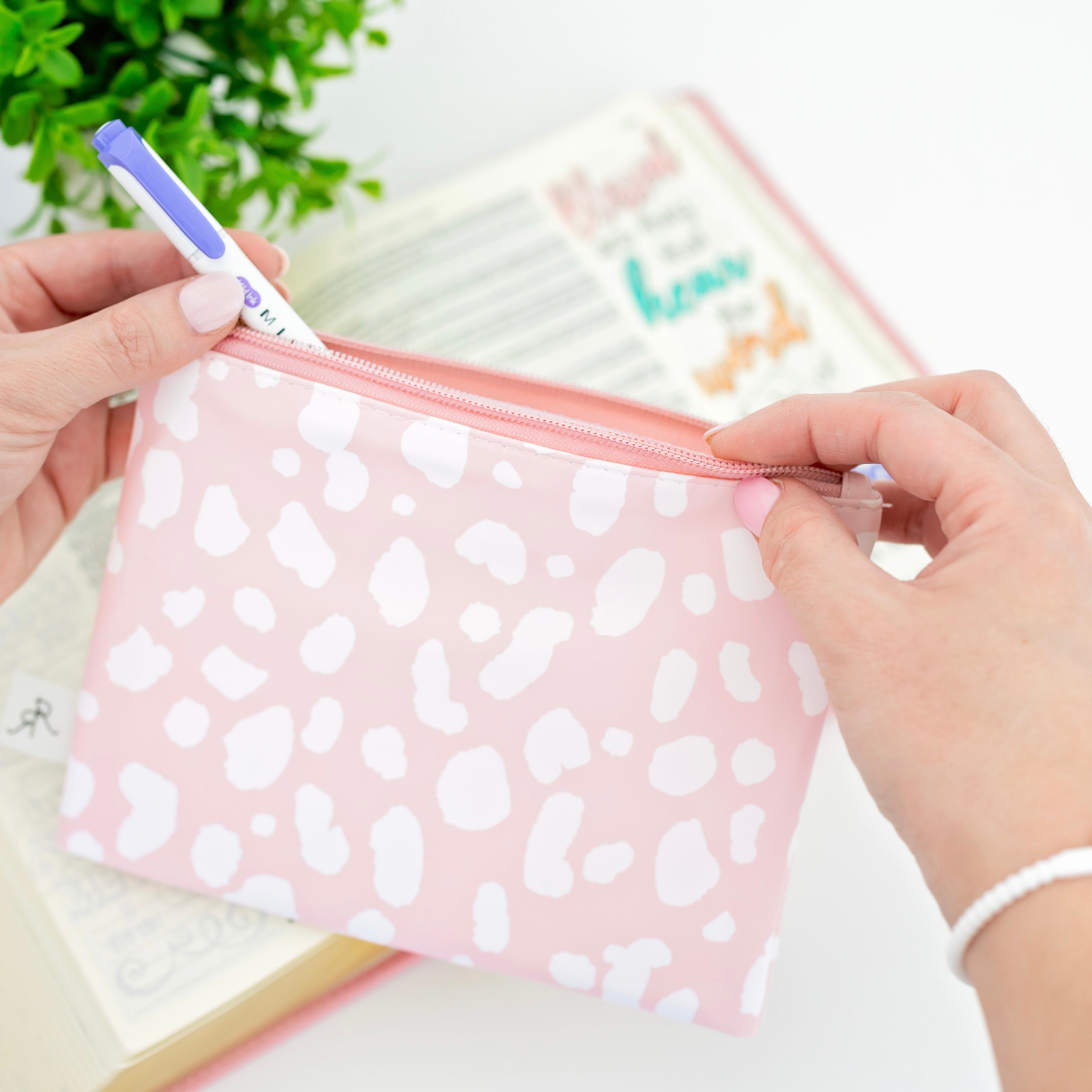 Woman putting pens in pouch