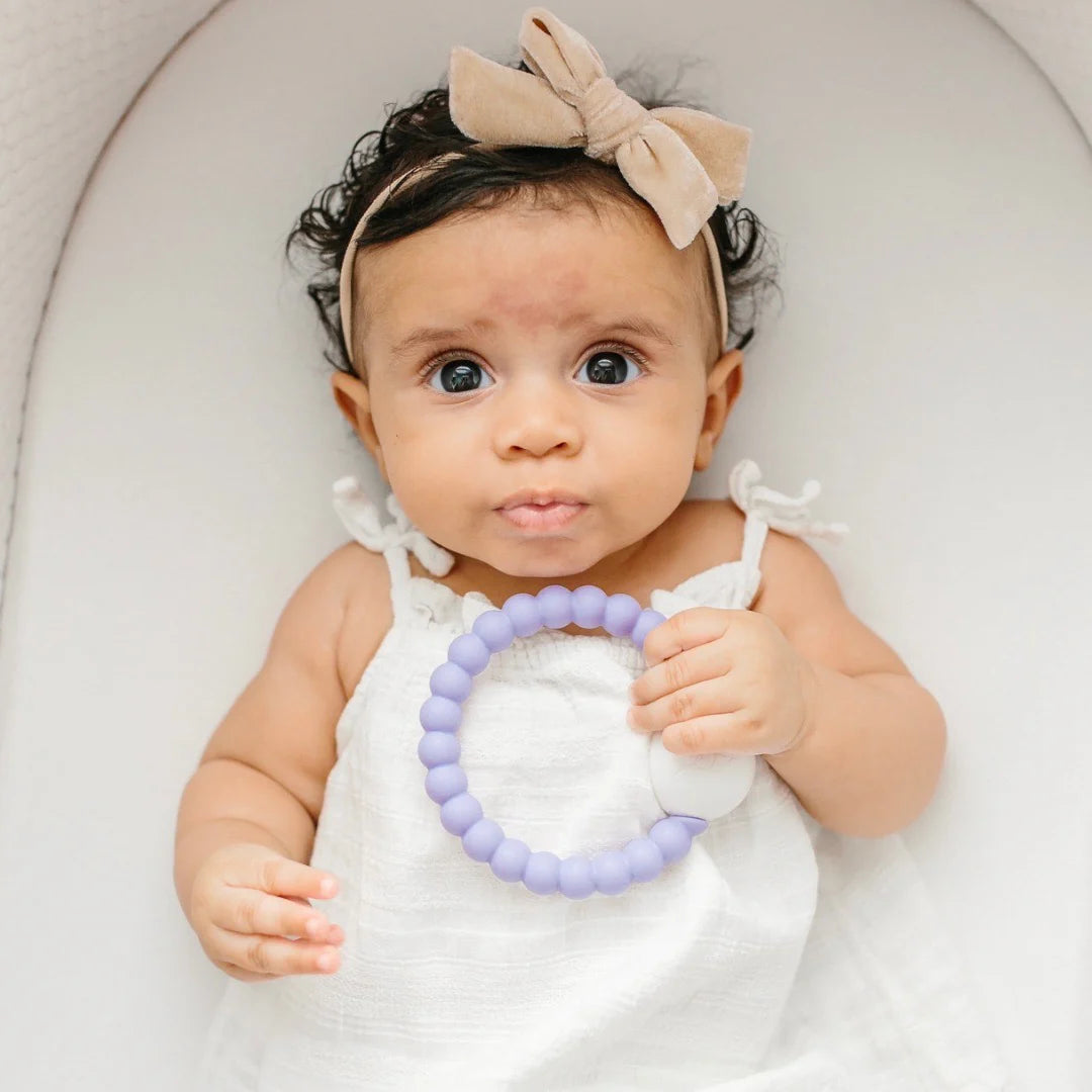 Baby playing with Cutie Teether Rattle