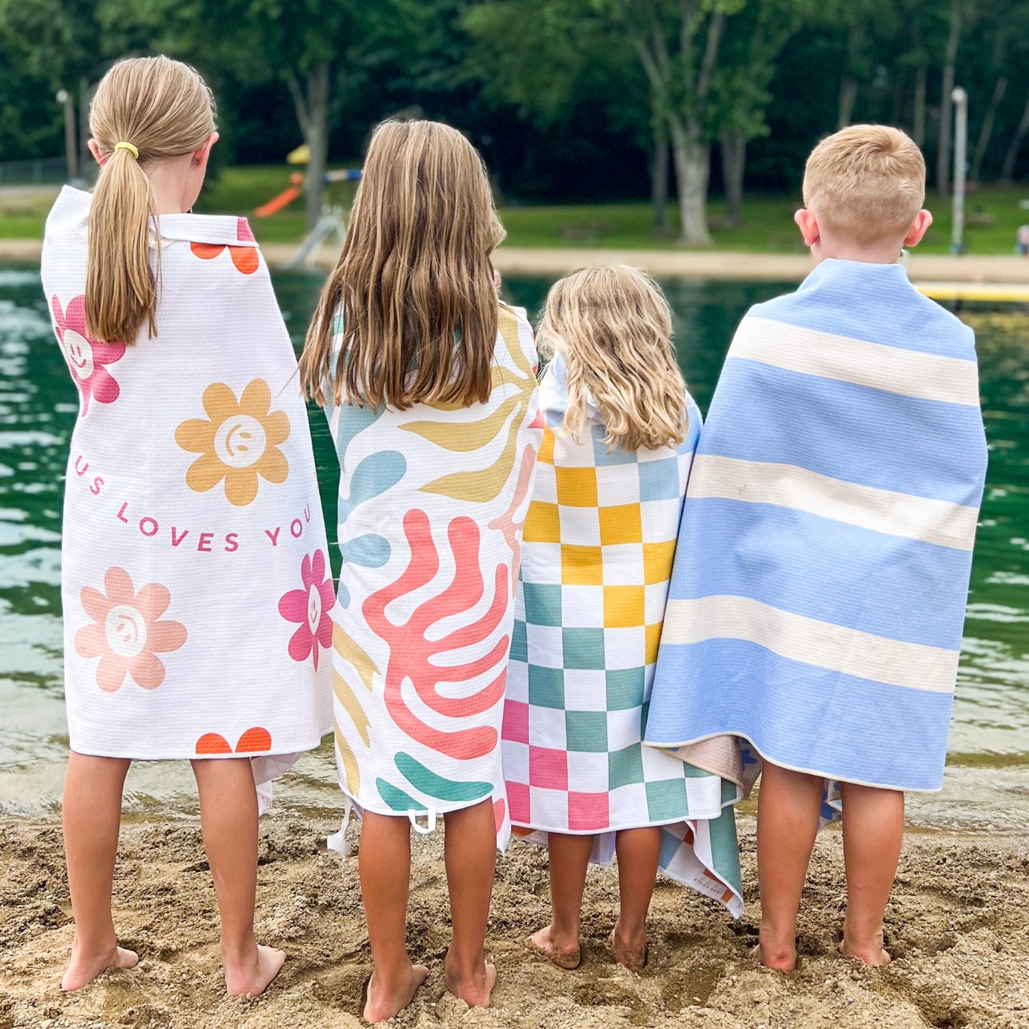 Kids wrapped in towels on beach
