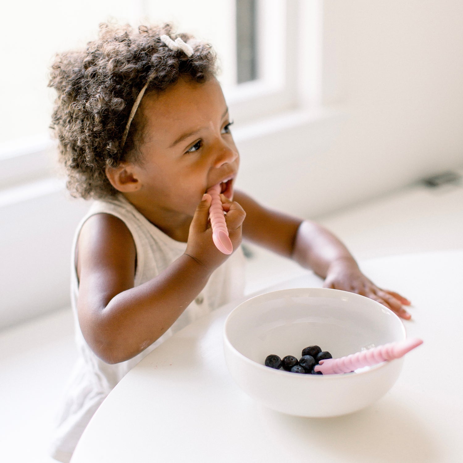 Toddler eating with tensils