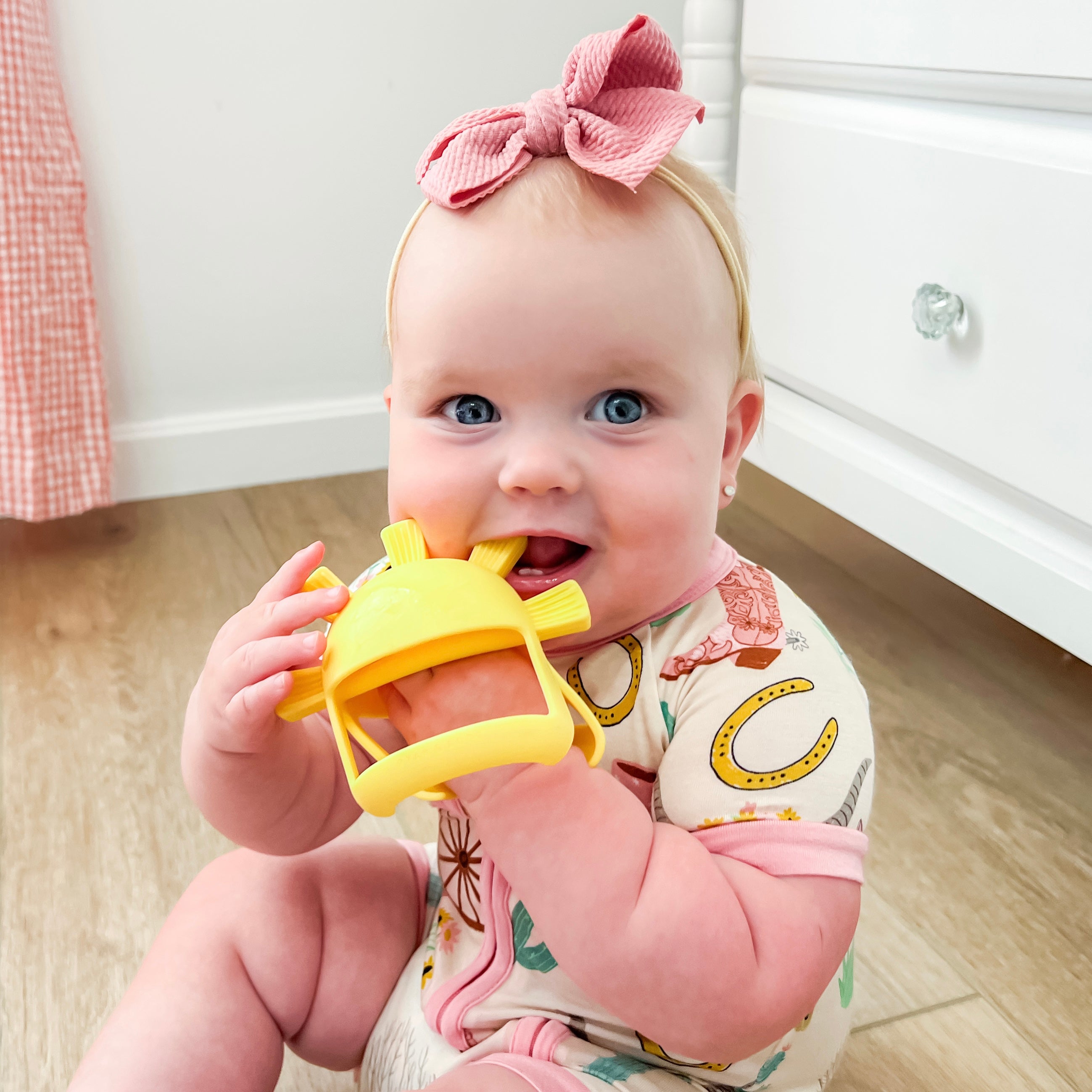 Baby using teething mitt